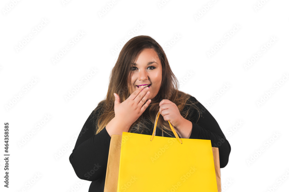 plus size woman looking at camera surprised holding yellow bag on a white background. plus size woman looking at camera surprised holding yellow bag on a white background.