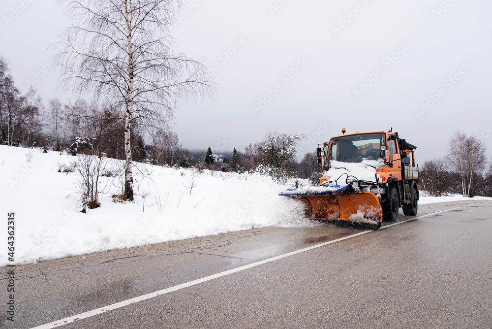Snowplow removing snow in the street after blizzard Snowplow removing snow in the street after blizzard