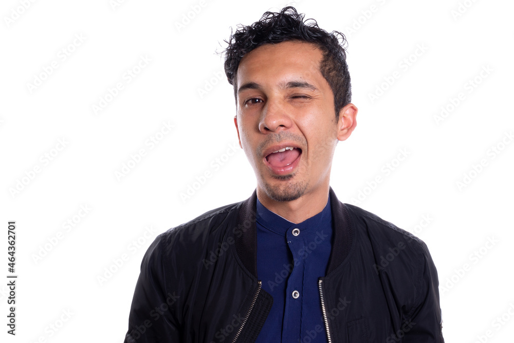 Latin man winking, isolated on white background. Man with beard winking at camera. Latin man winking, isolated on white background. Man with beard winking at camera.