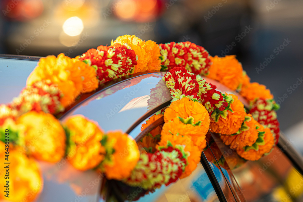 Bridal car decorated with orange and red flowers traditional indian wedding