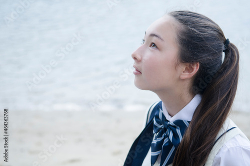 水辺で横向きの制服姿の少女 photo