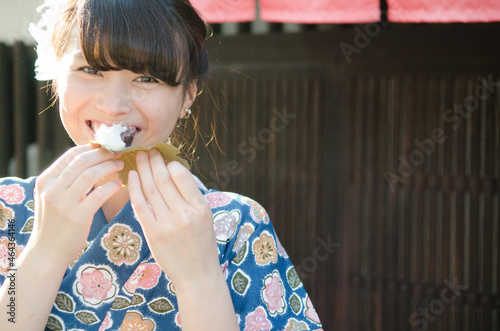 柏餅を食べながら笑う着物姿の女性 photo