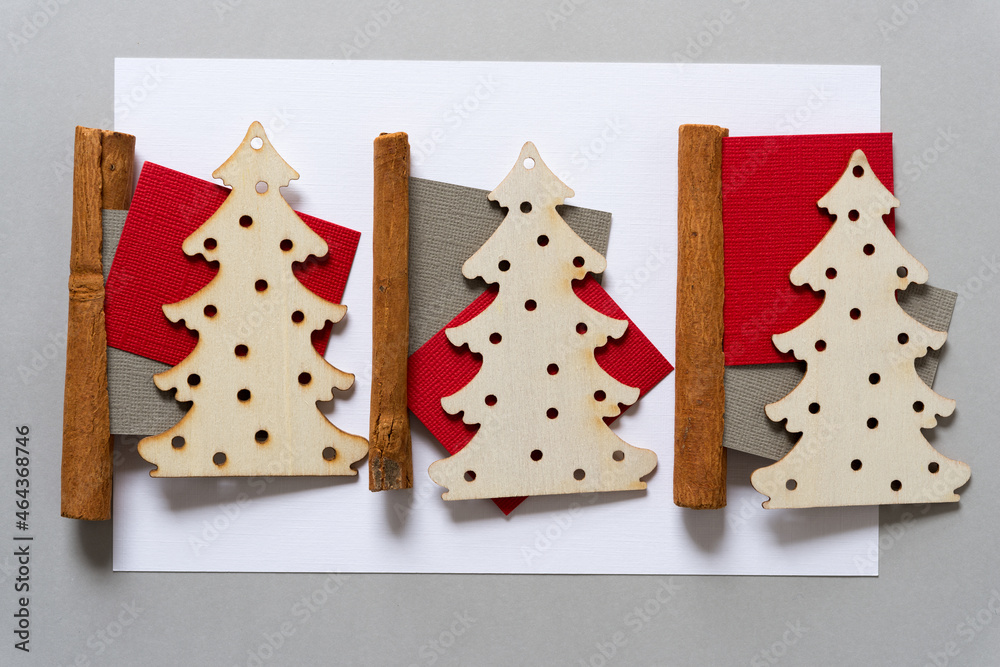 wooden christmas trees, cinnamon sticks, and paper squares