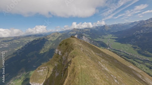 Drone shot made with an FPV drone. Flight over the Austrian mountain overlooking the city below. Amazing mountain view from aerial shooting. Pilot remote controlling.