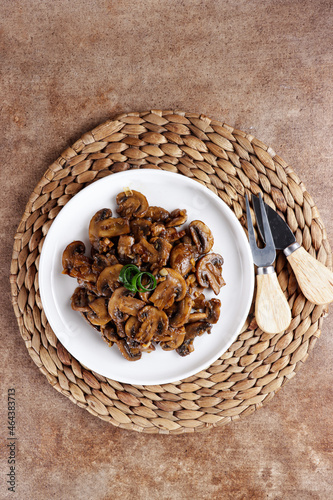 Tumis jamur kancing or Oseng jamur kancing. Mushrooms sauteed in a plate. photo