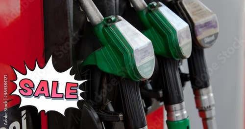 Animation of sale text in red over row of fuel pumps at petrol station photo