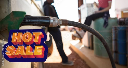 Animation of hot sale text over diverse man and woman filling truck with fuel pump at petrol station photo