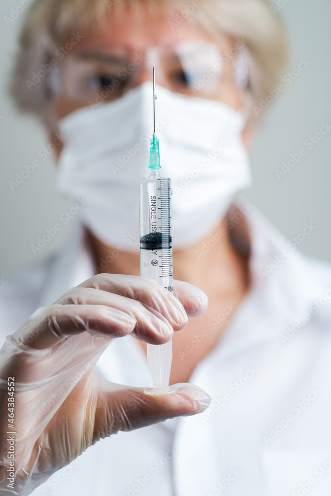 Doctor preparing a dose for a patient of the third vaccine for Covid-19 Doctor preparing a dose for a patient of the third vaccine for Covid-19