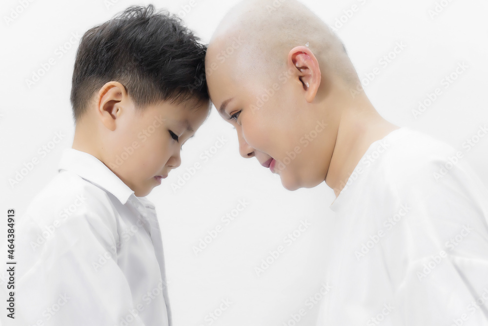 Young adult female cancer patient spending time with son at home, relaxing on the couch. Cancer and family support concept. Young adult female cancer patient spending time with son at home, relaxing on the couch. Cancer and family support concept.