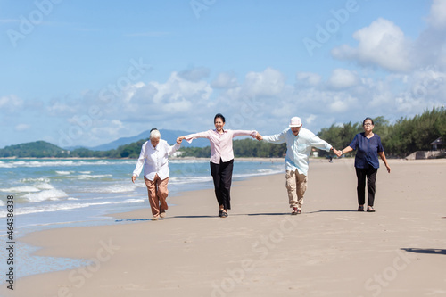 Happy family having fun on the beach. asian people senior couple happy and relax on the beach. Family vacation holiday © nikomsolftwaer