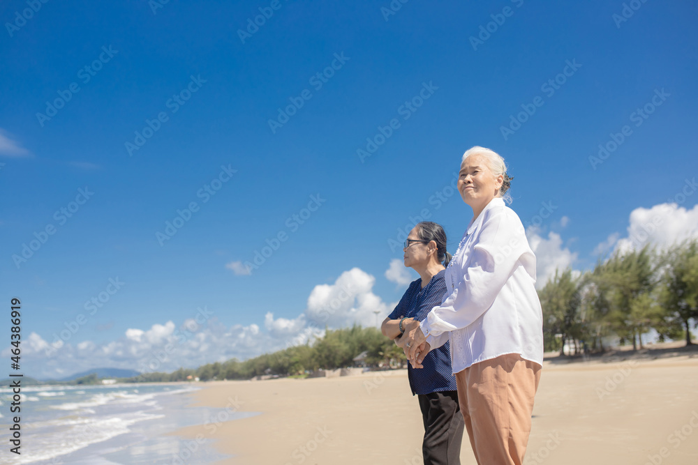 Portrait of happy senior asian female friends at beach. Senior woman friends relax at the beach. family travel and vacations concept Portrait of happy senior asian female friends at beach. Senior woman friends relax at the beach. family travel and vacations concept