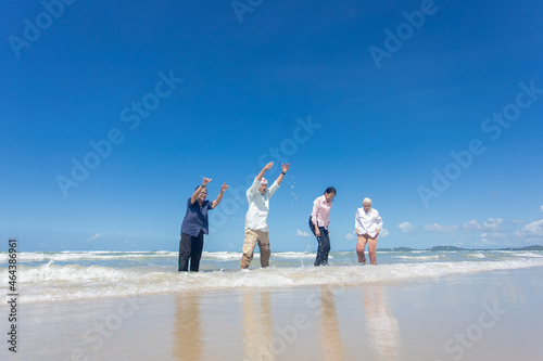 Asian Family Having Fun On Beach. Senior Woman On Holiday On Beach. family holiday and travel summer beach concept © nikomsolftwaer