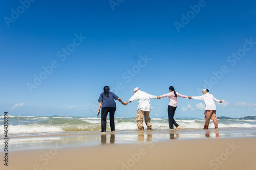 Asian Family Having Fun On Beach. Senior Woman On Holiday On Beach. family holiday and travel summer beach concept © nikomsolftwaer