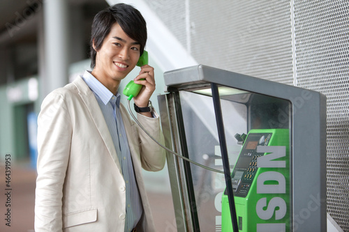 公衆電話で電話するビジネスマン photo