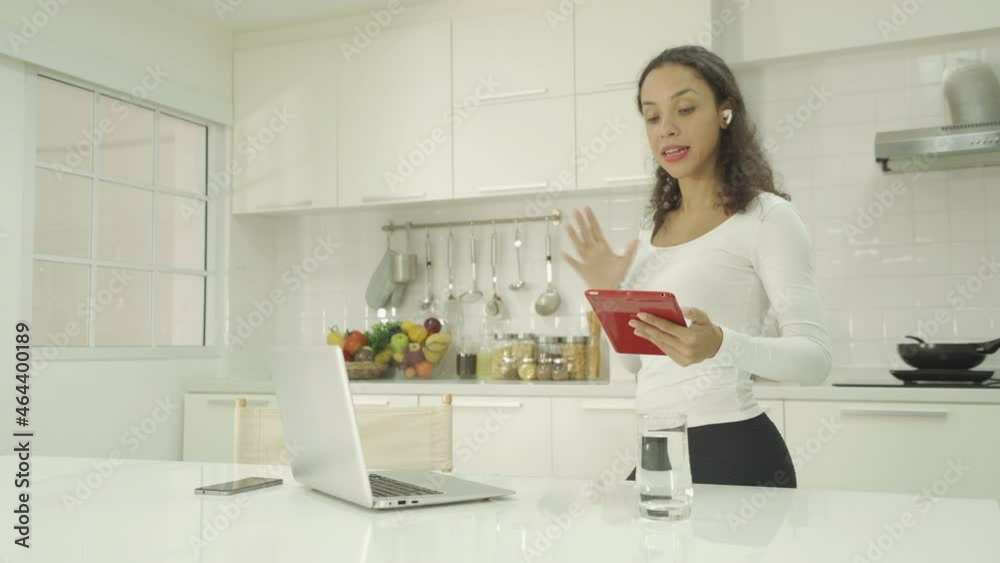 Portrait of happy smiling, latin woman talking, cooking food at home, video live on webcam video meeting with computer laptop, call conference, working online in kitchen. People lifestyle. Webinar Portrait of happy smiling, latin woman talking, cooking food at home, video live on webcam video meeting with computer laptop, call conference, working online in kitchen. People lifestyle. Webinar