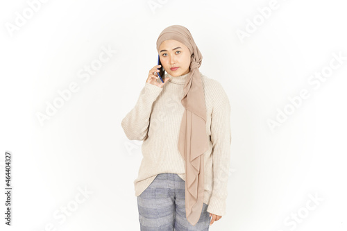 Talking on the phone With Serious Face of Beautiful Asian Woman Wearing Hijab Isolated On White Background