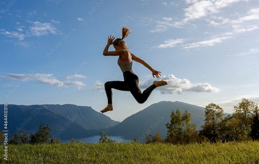 girl practices yoga in a mountain meadow girl practices yoga in a mountain meadow