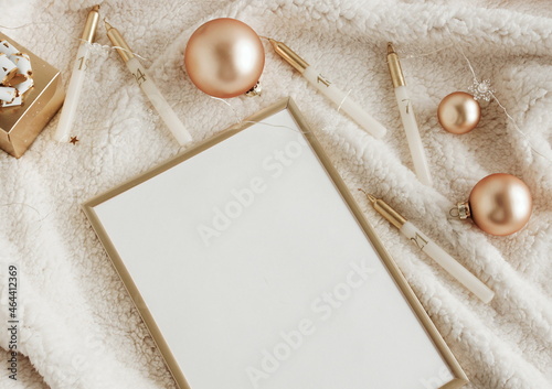 Gold frame mockup blank paper and Christmas decoration top view with copy spa...