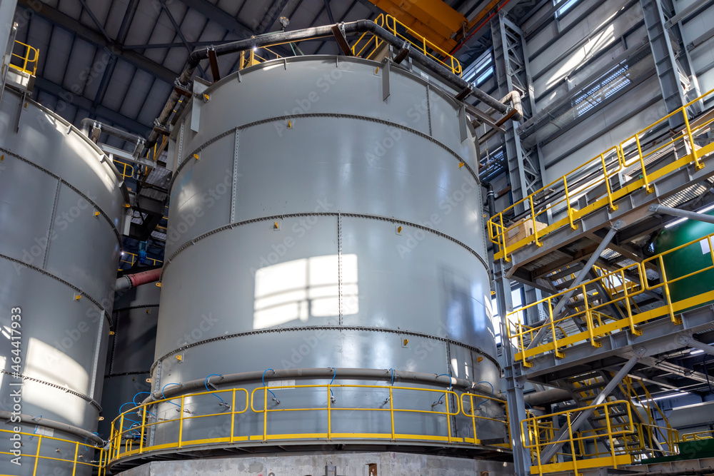 Oil and chemical storage tank in the mining factory. Above ground storage tanks can be used to hold materials such as petroleum, waste matter, water, chemicals, and other hazardous materials. Oil and chemical storage tank in the mining factory. Above ground storage tanks can be used to hold materials such as petroleum, waste matter, water, chemicals, and other hazardous materials.