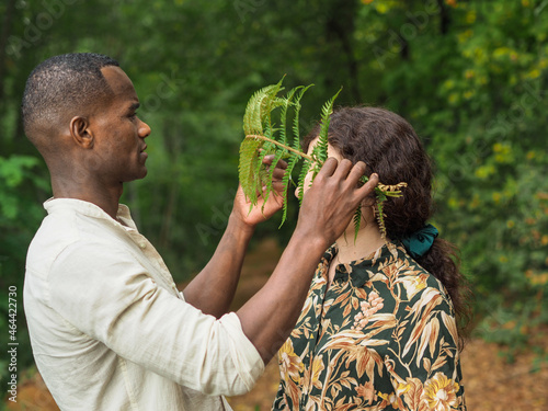 beautiful diverse ethnics couple in the forest in autumn photo