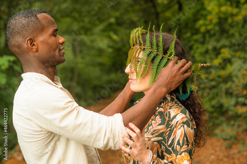 beautiful diverse ethnics couple in the forest in autumn photo