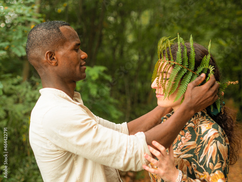 beautiful diverse ethnics couple in the forest in autumn photo