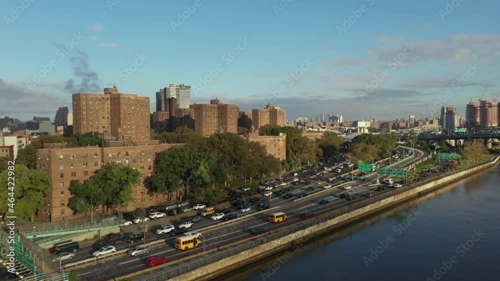 aerial shot follows cars uptown on the Harlem River Drive in New York City, schoolbuses in interest aerial shot follows cars uptown on the Harlem River Drive in New York City, schoolbuses in interest