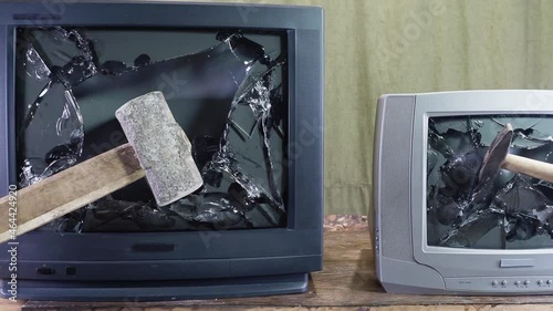 Smashed old kinescope television. Sledgehammer smashes old TV. Broken monitor