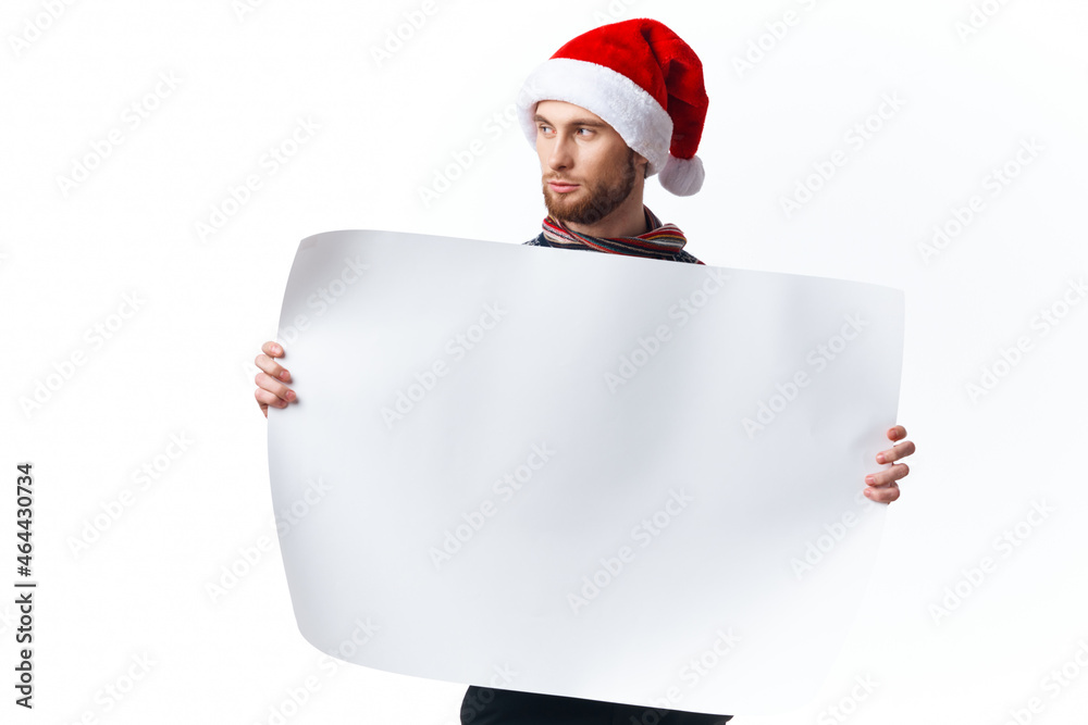Cheerful man in a christmas hat with white mockup poster christmas copy-space studio