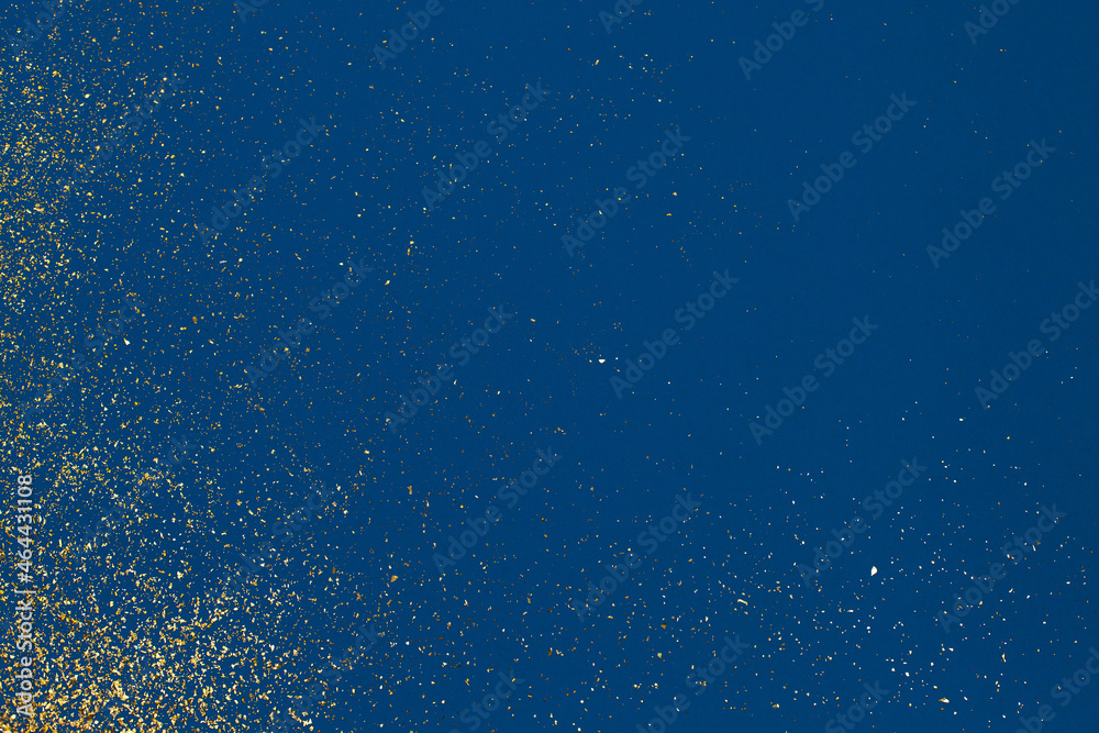 Christmas Gold glitter on blue background. Holiday abstract texture