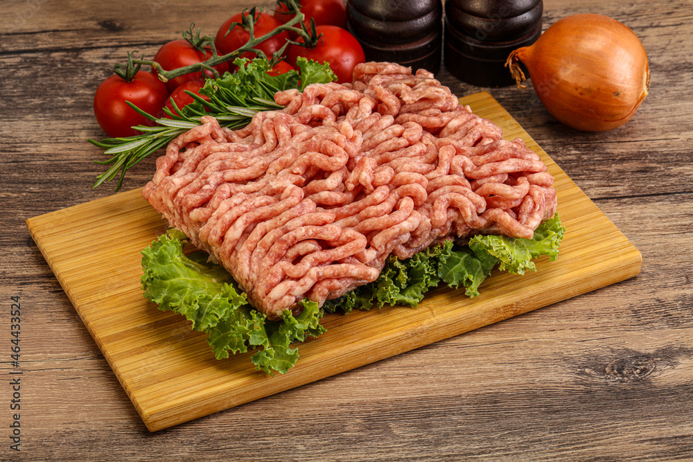 Raw pork minced meat over board Raw pork minced meat over board