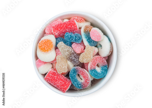 Fruit flavour gums candies with a sour sugar coating in ceramic bowl on white background.