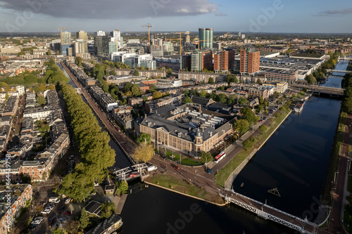 Muntgebouw and skyline of Dutch city Utrecht with financial and central train station area in the background with canal and floating homes in the foreground photo