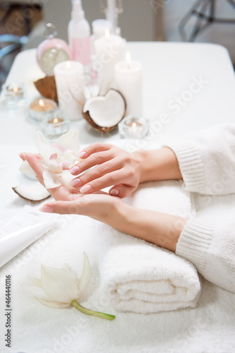 beauty delicate hands with manicure holding flower lily.