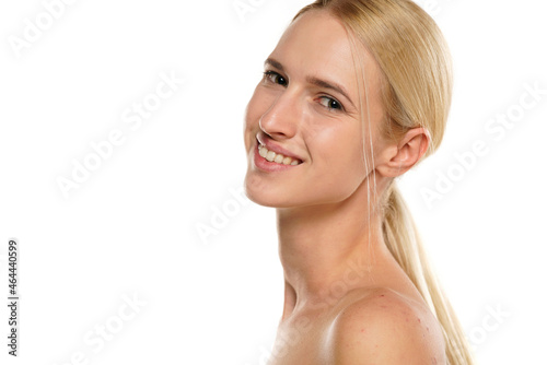 Side view of a young blond smiling woman without makeup