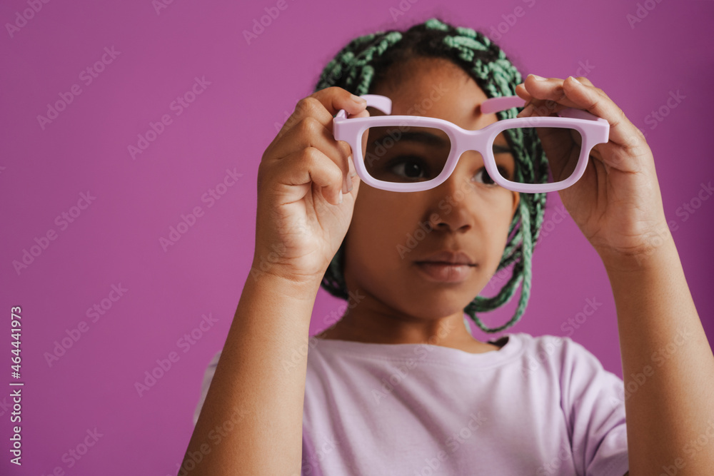 Black girl with afro pigtails posing with sunglasses Black girl with afro pigtails posing with sunglasses