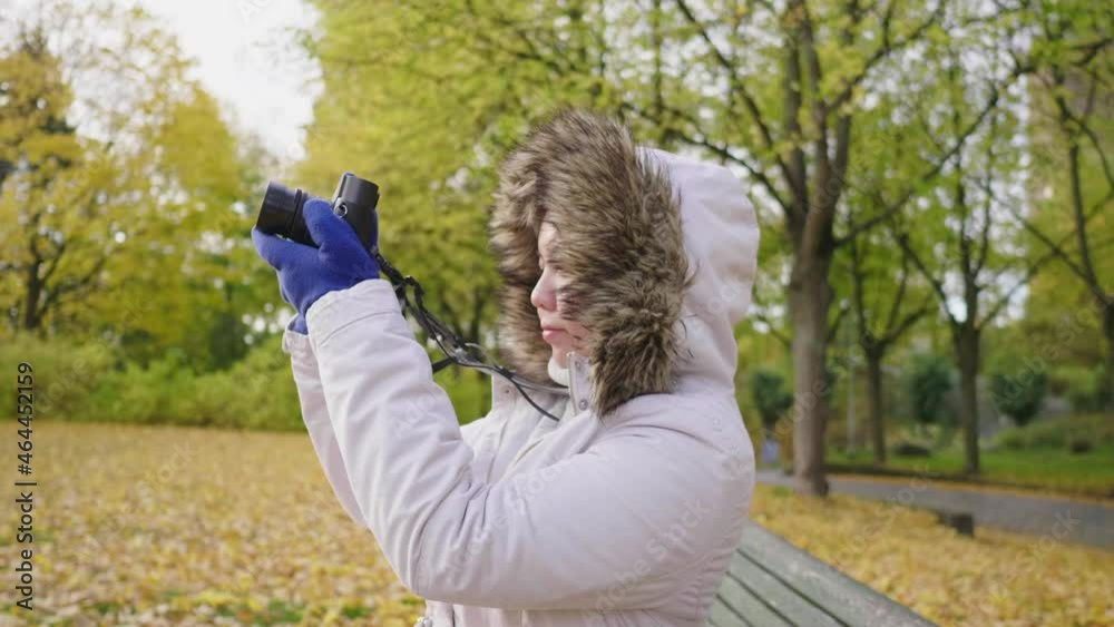Asian woman taking a photo of view at park in Autumn. Autumn outfits, Good weather, yellow leaves falling on the street. A lot of tree background, Stockholm, Sweden in Autumn concept Asian woman taking a photo of view at park in Autumn. Autumn outfits, Good weather, yellow leaves falling on the street. A lot of tree background, Stockholm, Sweden in Autumn concept