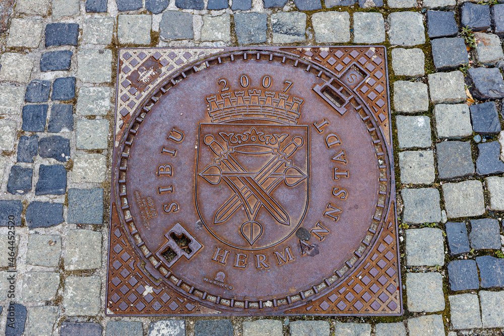A manhole cover with coat of arms of Sibiu in Romania