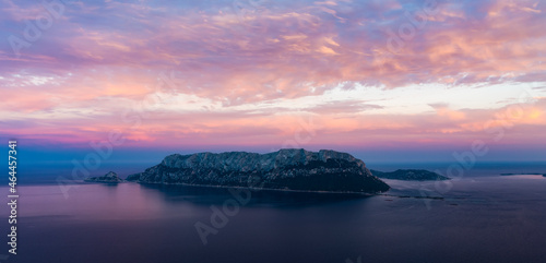View from above, stunning aerial view of Tavolara Island during a dramatic sunset. Picture taken from Capo Ceraso, Sardinia, Italy.