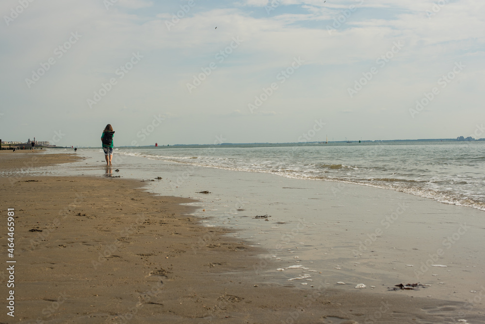 person walking on the beach