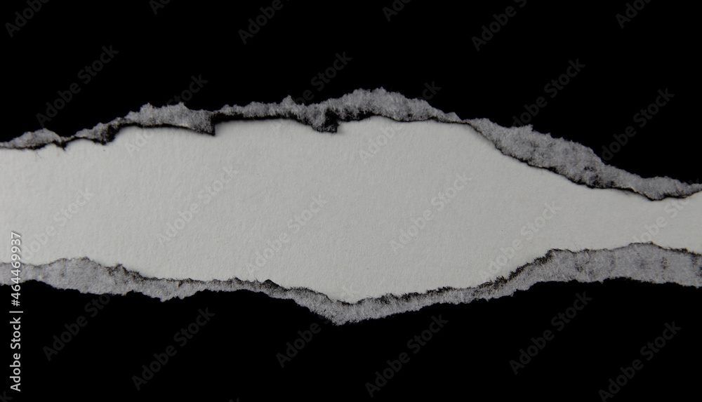 Black paper with torn marks placed on a white background. image for background with copy space Black paper with torn marks placed on a white background. image for background with copy space