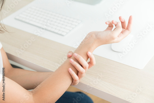 Concept of office syndrome, woman having wrist pain from using computer, wrist pain.