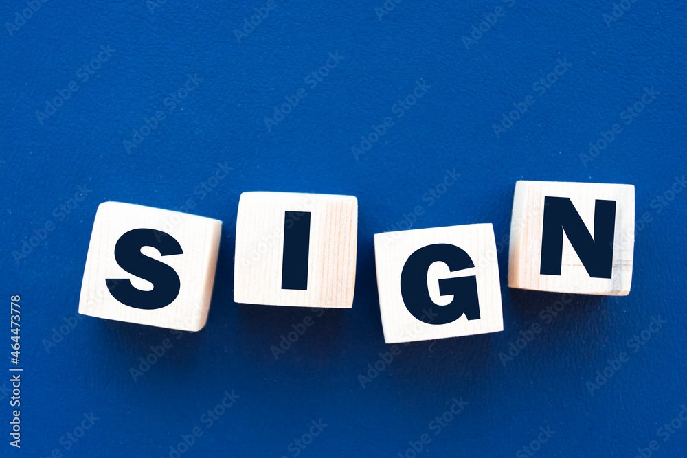 Obraz premium Motivational words: sign in 3d wooden alphabet letters on a blue background with copy space, business concept