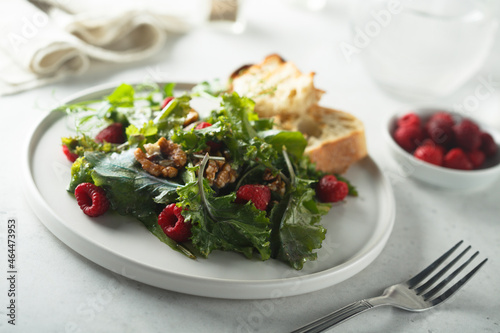 Healthy green salad with raspberry and walnut