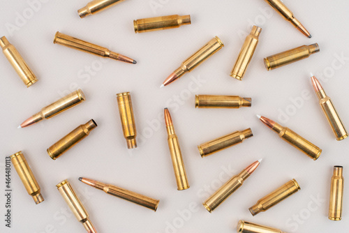 Billede på lærred Pile of rifle bullets isolated on grey background. Top view.