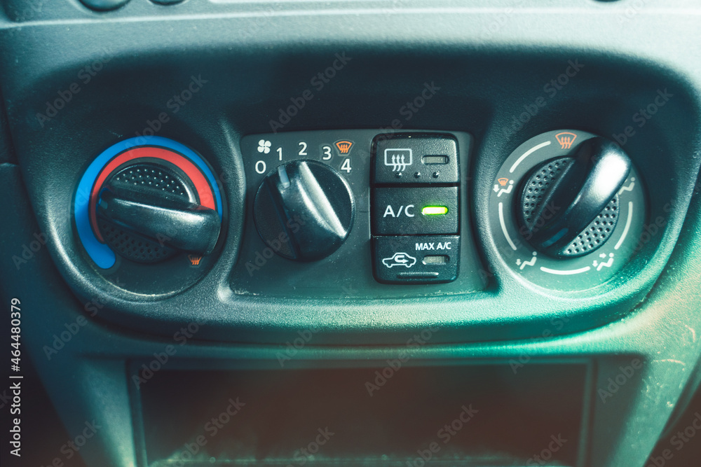 Close up Instrument automobile panel with climat control view with air conditioning buttons.