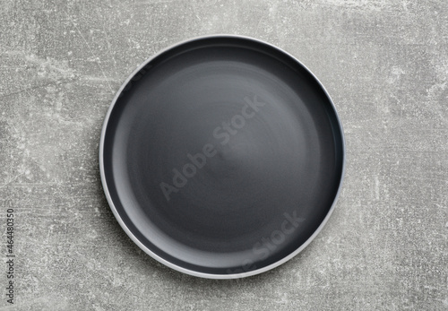 New dark plate on light grey table, top view