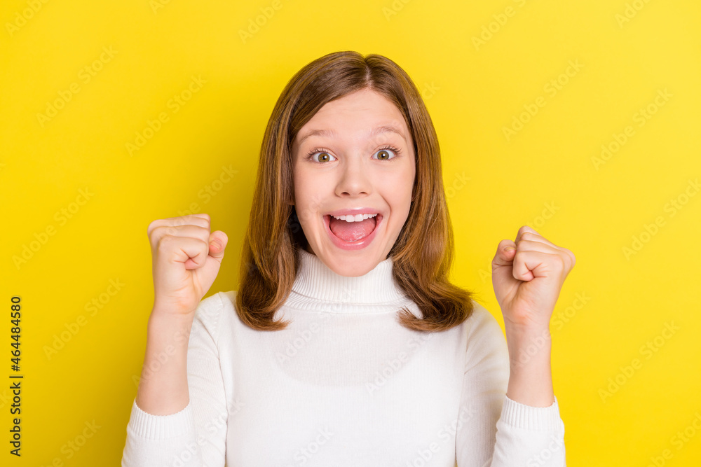 Photo of young girl happy positive smile rejoice win winner victory lucky success isolated over yellow color background Photo of young girl happy positive smile rejoice win winner victory lucky success isolated over yellow color background