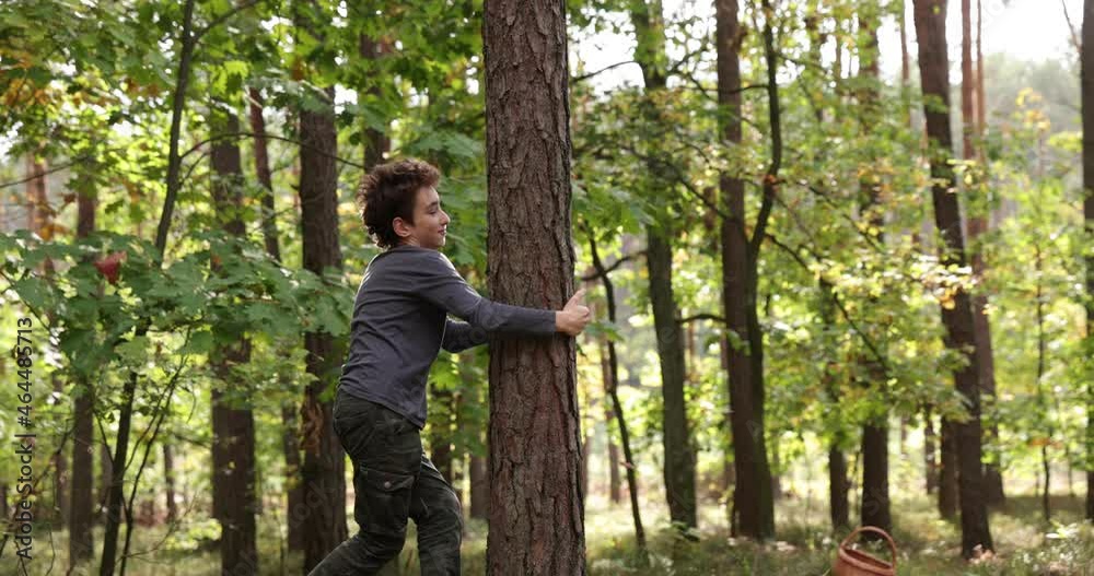 Boy hugs around a tree showing his love to nature. slow motion. 4K. Love and nature concept. Boy hugs around a tree showing his love to nature. slow motion. 4K. Love and nature concept.