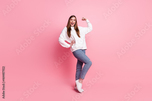 Full length photo of young girl happy positive smile show muscles hand athlete sportive isolated over pastel color background